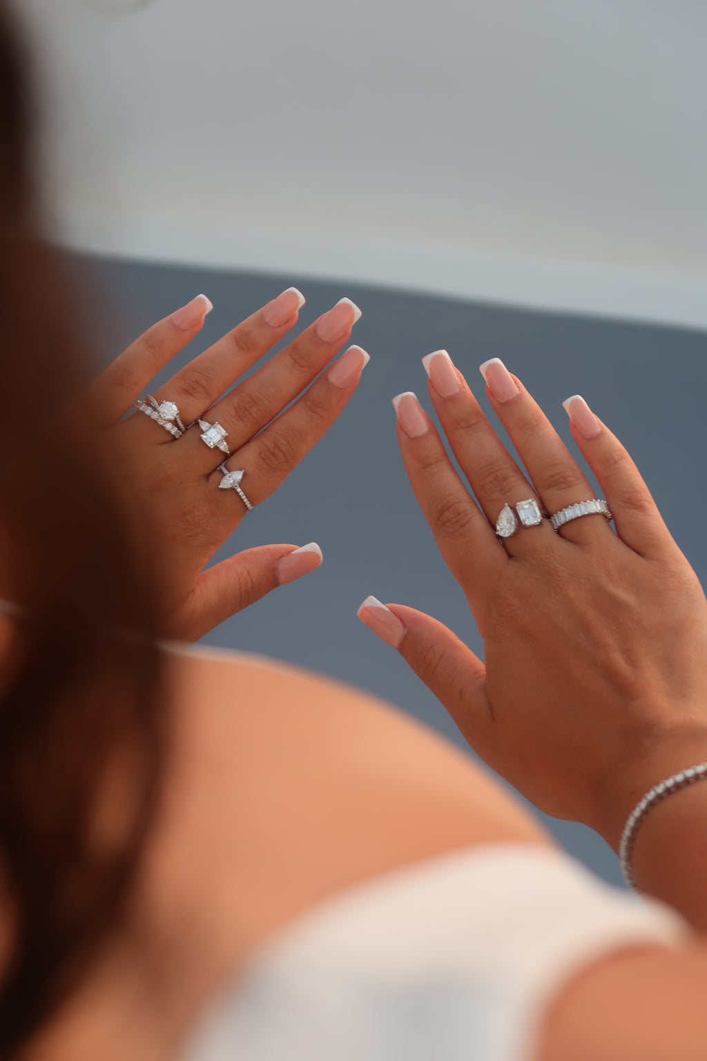 Hands displaying baguette cut moissanite eternity band against soft background highlighting continuous stone setting