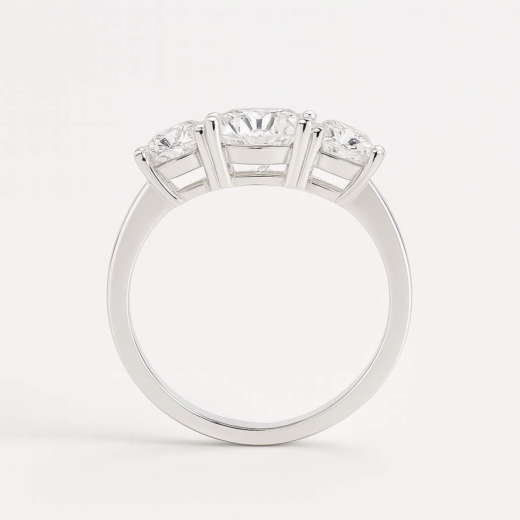 Round cut moissanite three-stone engagement ring photographed from above showcasing symmetrical stone placement and band design