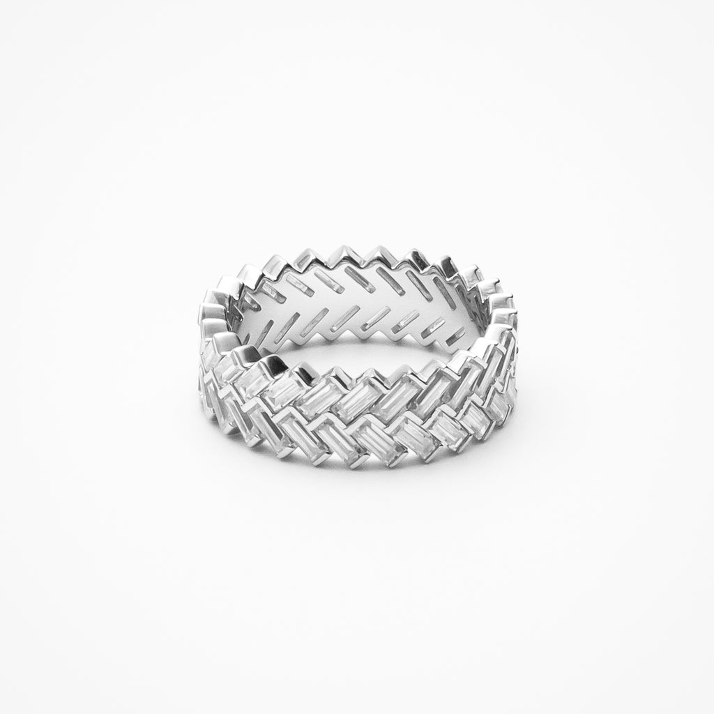 Baguette cut moissanite eternity band with interwoven basketweave pattern in white gold setting on clean white background showcasing geometric design and continuous sparkle