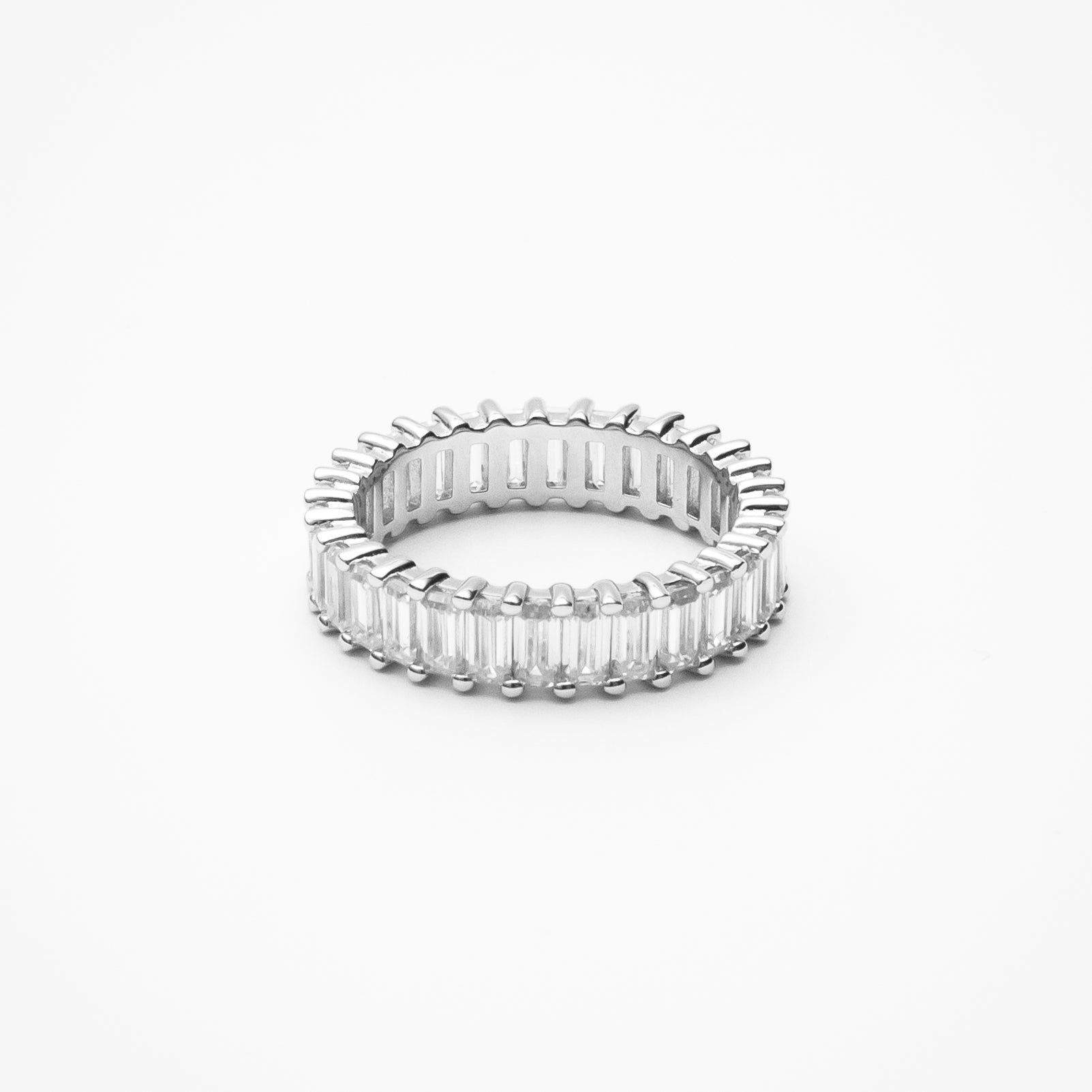 Baguette cut moissanite eternity band with continuous emerald cut stones in white gold setting on clean white background