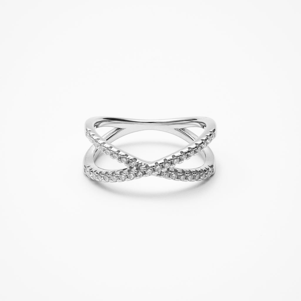 Infinity crossover pavé moissanite wedding band in white gold setting on clean white background showcasing intertwined design and continuous sparkle