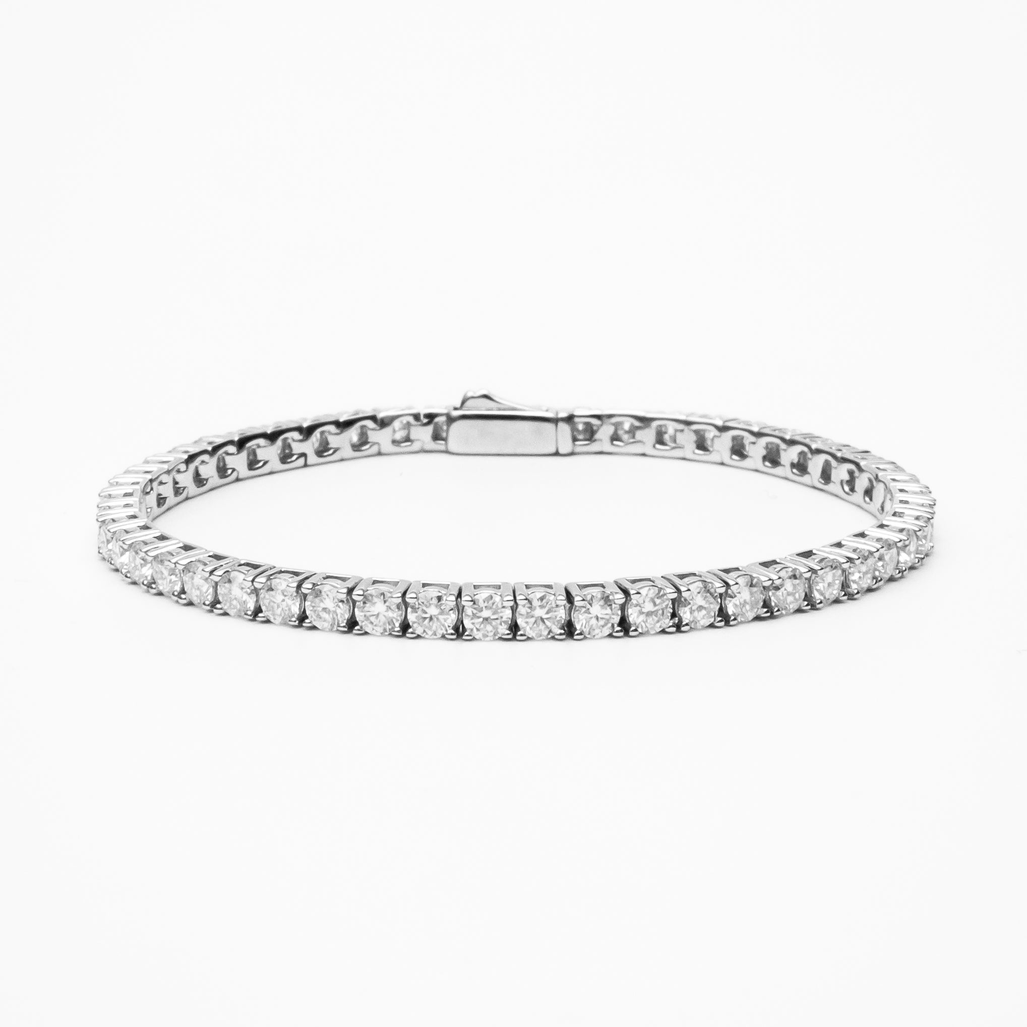 Moissanite tennis bracelet with round brilliant stones in white gold setting on clean white background showcasing continuous line of sparkle and secure clasp
