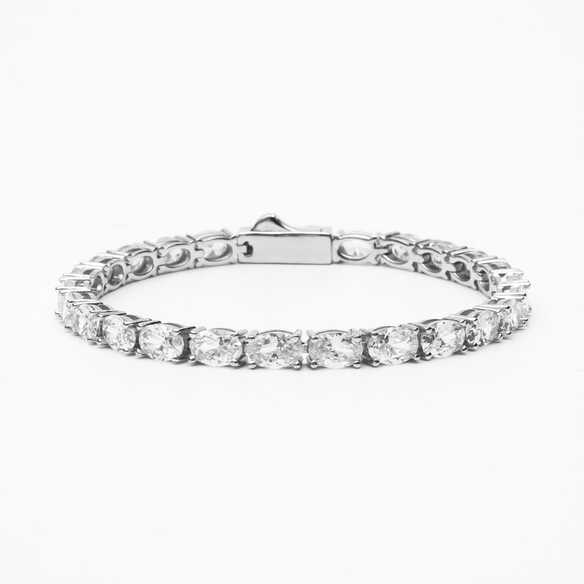 Oval cut moissanite tennis bracelet with continuous line of oval stones in white gold setting on clean white background