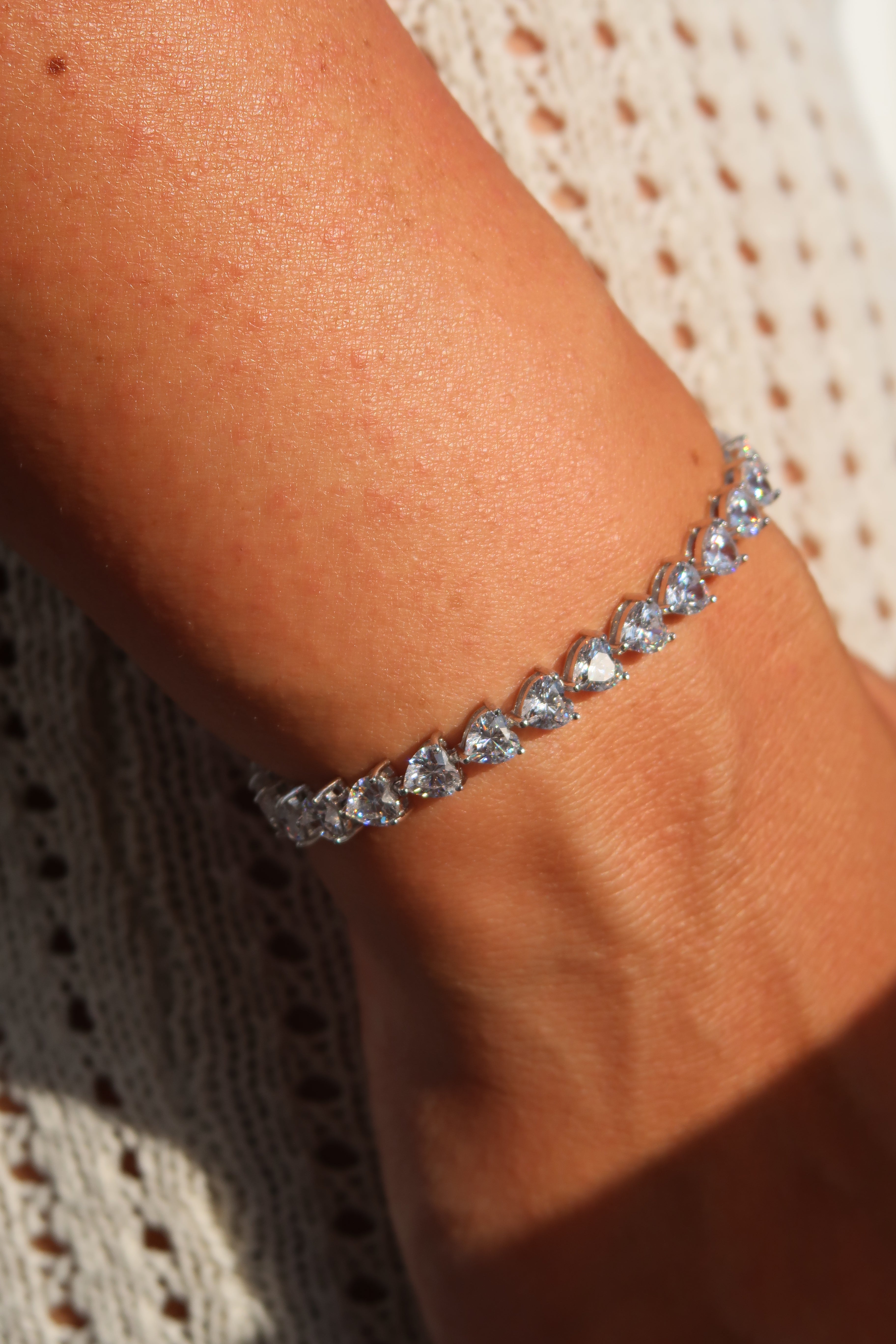 Heart cut moissanite tennis bracelet worn casually demonstrating elegant everyday styling