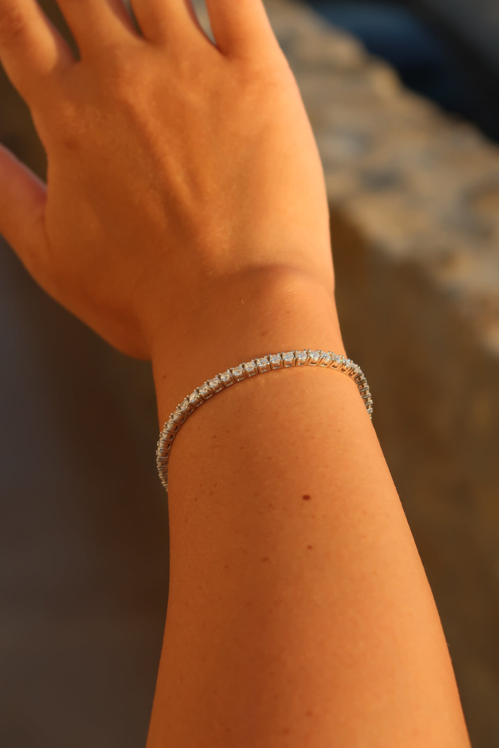 Moissanite tennis bracelet worn on wrist against natural background showcasing elegant everyday styling