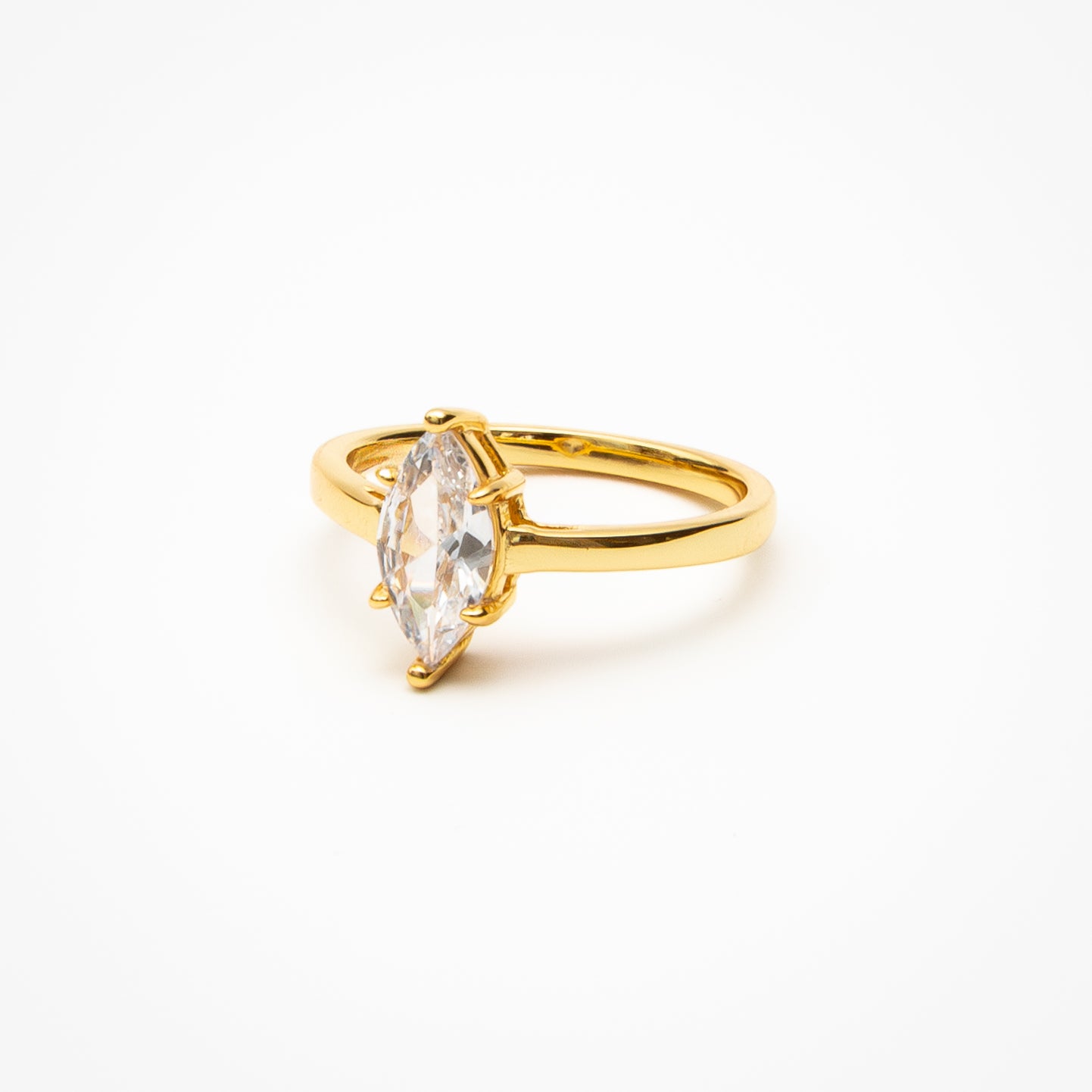 Marquise cut cubic zirconia solitaire engagement ring in yellow gold setting on clean white background showcasing elongated diamond shape and classic solitaire design