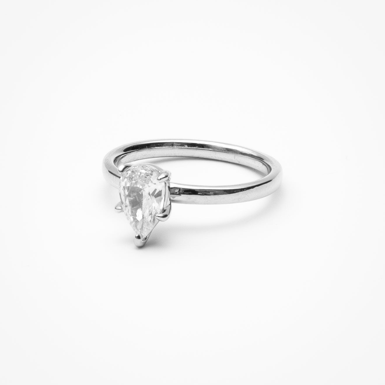 Pear cut cubic zirconia solitaire engagement ring in white gold setting on clean white background showcasing teardrop shape and elegant simplicity