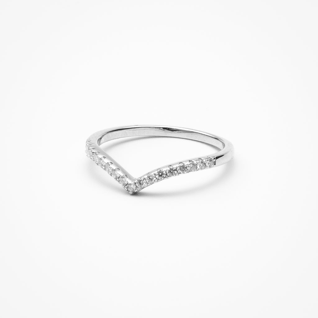 Curved pavé moissanite wedding band in white gold setting on clean white background showcasing V-shaped contour design for stacking with engagement rings