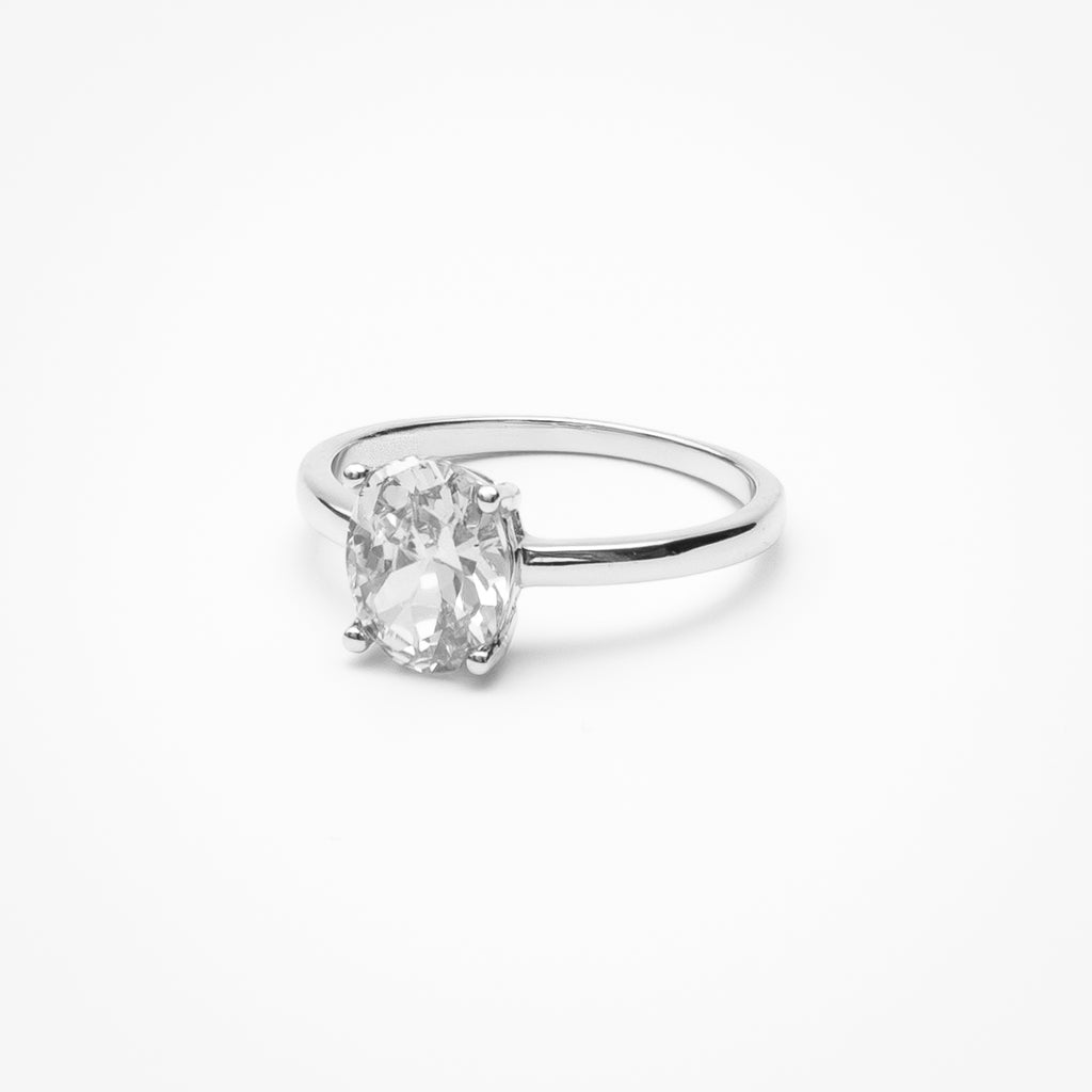 Oval cut cubic zirconia solitaire engagement ring in white gold setting on clean white background showcasing low profile design and classic elegance