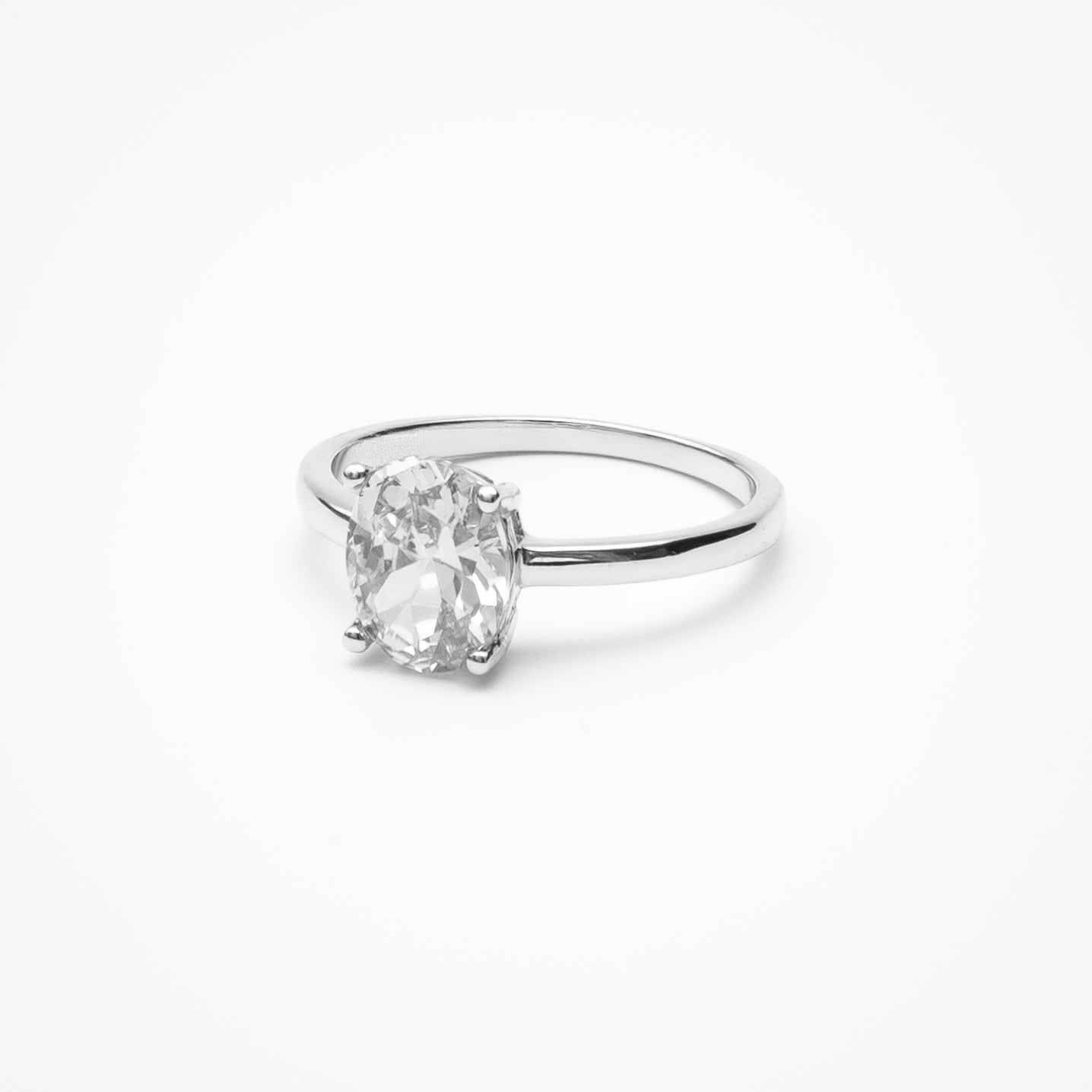 Oval cut cubic zirconia solitaire engagement ring in white gold setting on clean white background showcasing low profile design and classic elegance