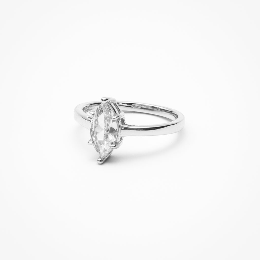Marquise cut cubic zirconia solitaire engagement ring in white gold setting on clean white background showcasing elongated stone shape and low profile design