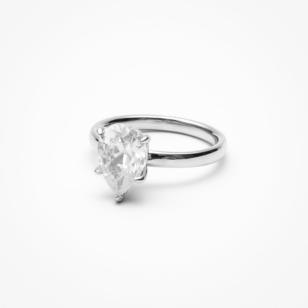 Pear cut cubic zirconia solitaire engagement ring in white gold setting on clean white background showcasing teardrop shape and elegant simplicity