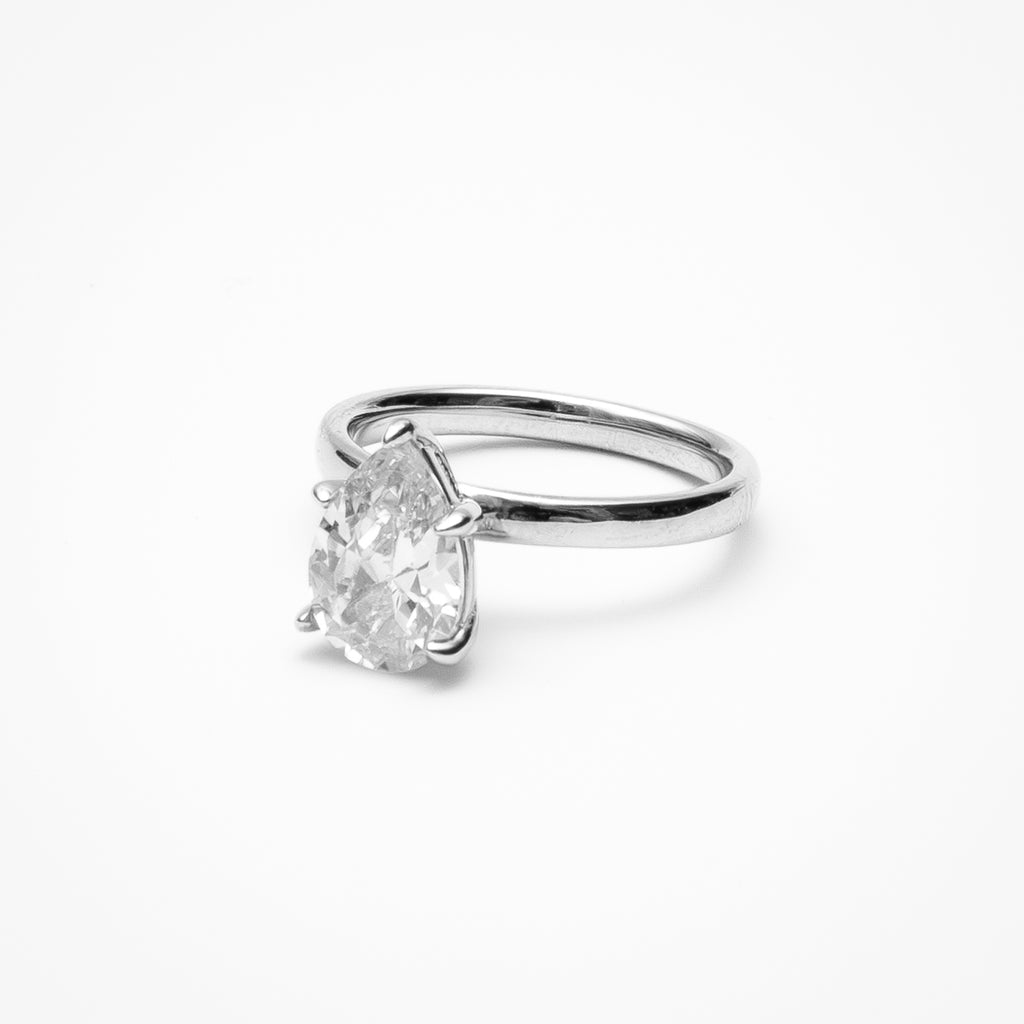 Pear cut cubic zirconia solitaire engagement ring in white gold setting on clean white background showcasing teardrop shape and elegant simplicity