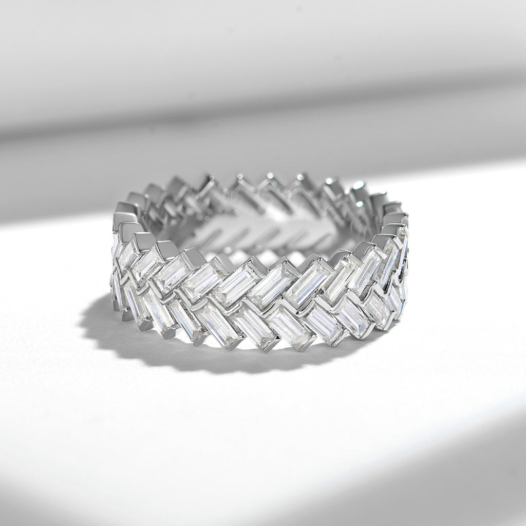 Baguette cut moissanite eternity band with interwoven basketweave pattern in white gold setting on clean white background showcasing geometric design and continuous sparkle